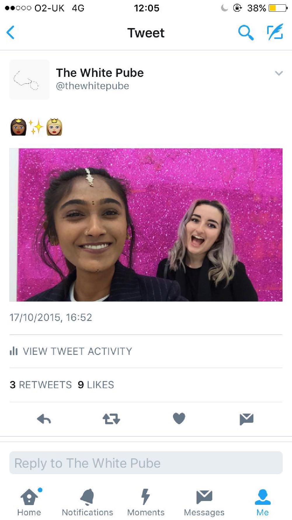 a picture of gab and zarina aged 21 smiling with a pink shiny artwork behind them