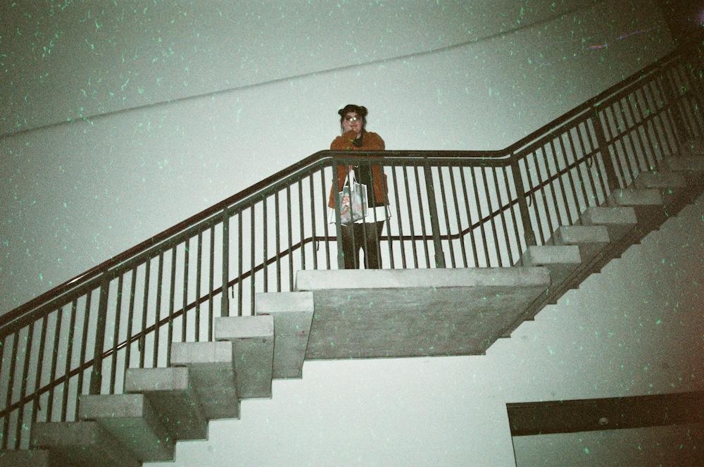 gab looking down from big concrete stairs