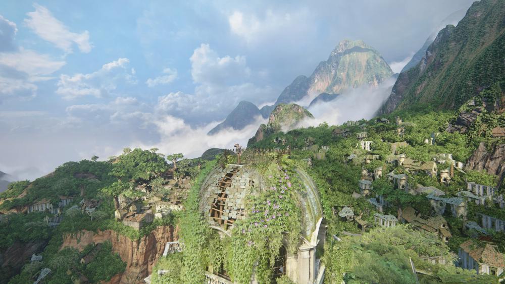 a wide shot of a beautiful tropical forest scene on an island off Madagascar with some delapidated buildings poking out between the greenery, domed rooves, and cloudy mountains in the background