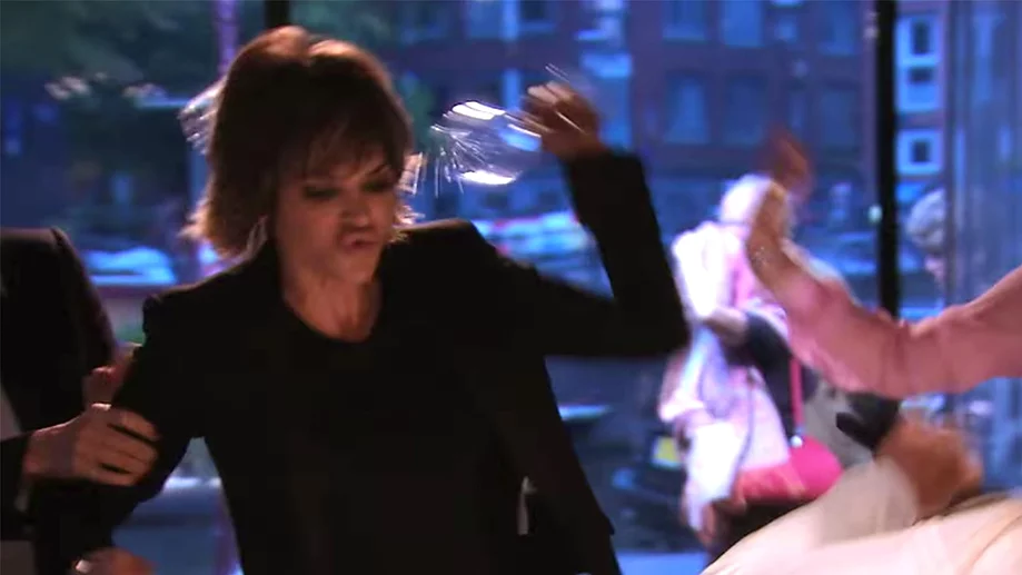 Lisa Rinna halfway through smashing a glass at the amsterdam dinner drama looking absolutely furious