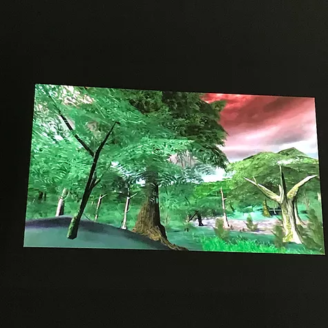 a CGI forest with a dramatic red sky