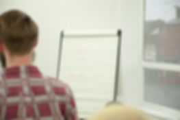 a shot of a note board over someone&rsquo;s shoulder