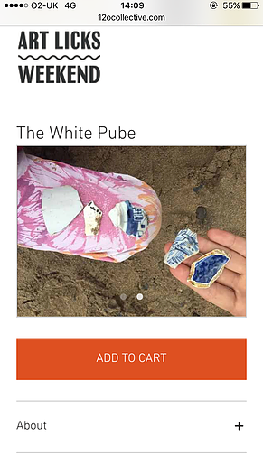 a white hand holds small pieces of broken china over sand