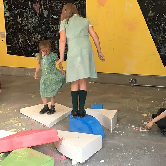 Ivy and Erin are stood on top of huge pieces of chalk as if they&rsquo;re playing offground tick