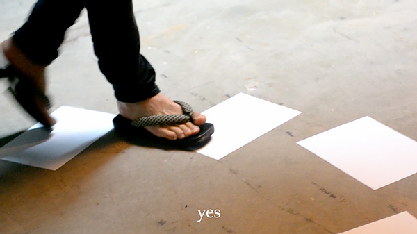 someone is walking over white a4 pieces of paper on the floor