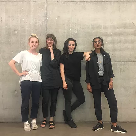 a photo of lou macnamara, eva duerdan, gabrielle and zarina against a grey concrete wall in central saint martins