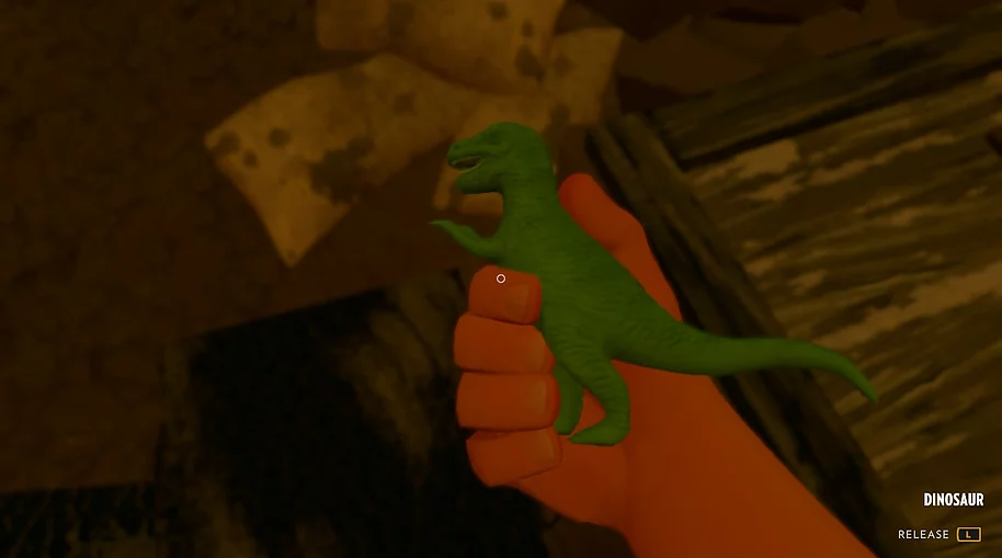 we hold a small plastic green dinosaur toy in one hand