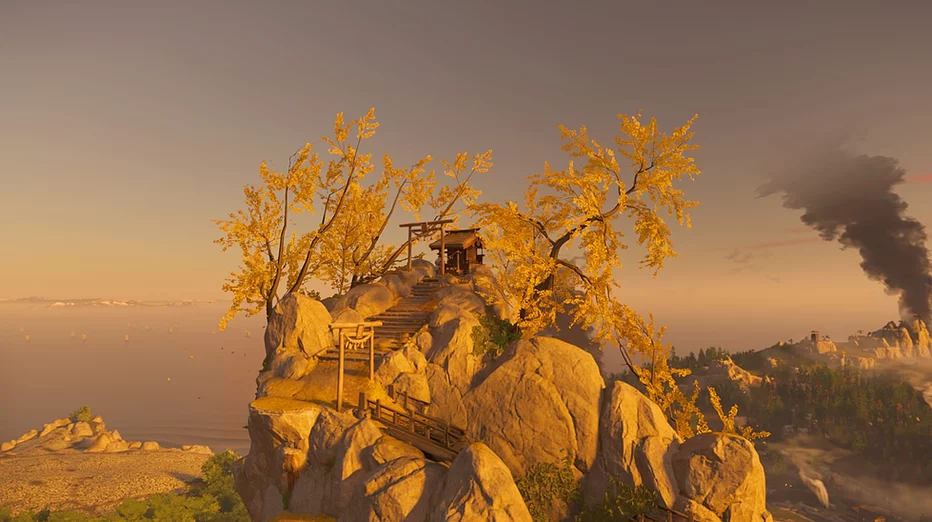 Gingko trees on the top of a mountain that has a temple at its top