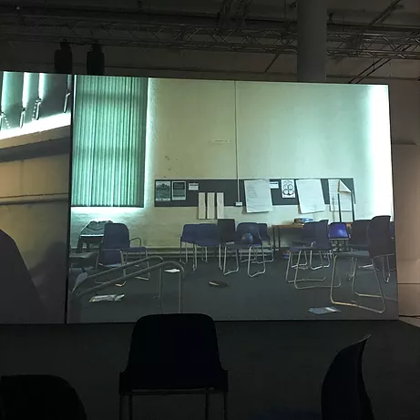 an image inside a school with a noticeboard and chairs in a mess all over the room