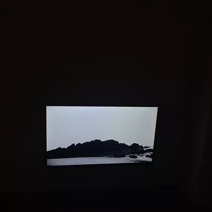 black rocks against a flat white sky