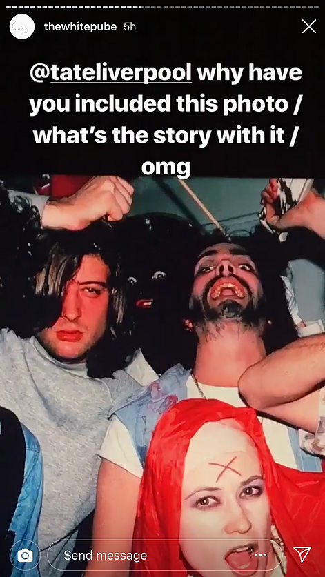 a screenshot of the white pube instagram story showing a group photo taken at a party. There are three white people  and then in between them someone is doing a wide eyed expression in black face. The caption above says @ tate liverpool why have you included this photo / what&rsquo;s the story with it / omg